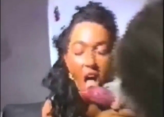 Brunette with fancy hair sucking on a dog dick