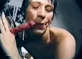 Sweet short-haired brunette is sucking a dog dick